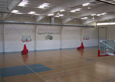 a indoor basketball court with red balls